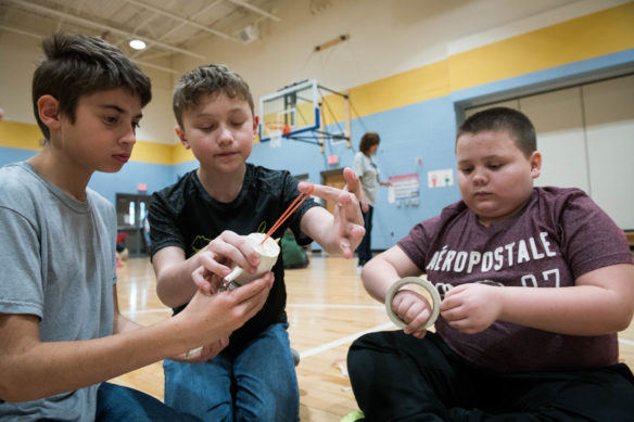 Noah Hartman, left, Kristian Milliner and Tanner Stevens, 5th-graders at Mt. Washington Elementary School (Bullitt County) build a rubber band powered car as part of the STEM challenge. Photo by Bobby Ellis, March 8, 2018