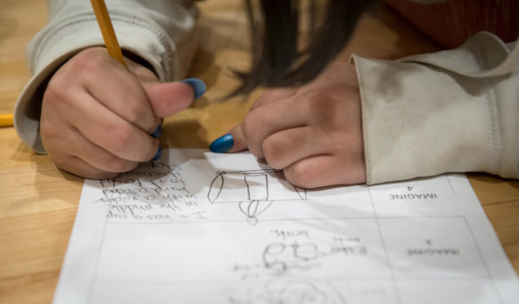 Carli Morgan, a 5th-grader at Mt. Washington Elementary School (Bullitt County), draws up a design for a rubber band powered car during the STEM challenge. Photo by Bobby Ellis, March 8, 2018