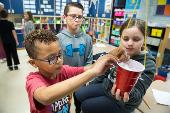 Max Bautista, left, Isaiah Taylor and Keile Allen, 5th-graders at Graves Central Elementary, work on making cup that will protect an egg during a fall in Andria Thompson's science class. Photo by Bobby Ellis, March 28, 2018