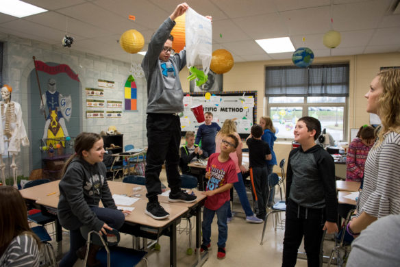 Max Bautista, a 5th-grader at Graves Central Elementary (Graves County) stands on a desk to test the effectiveness of a parachute made by his group for a lab in Andria Thompson's science class. Photo by Bobby Ellis, March 28, 2018