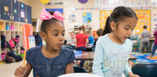 Teaghin Wiggins, left, and Tori Garcia work on math problems in Andrea Kemp's kindergarten class. Photo by Bobby Ellis, March 28, 2018