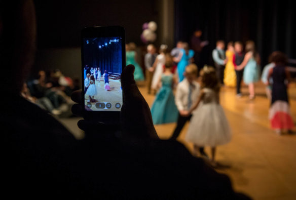 A Graves Central Elementary parent records the First Grade Fairy Tale Ball on his phone. Photo by Bobby Ellis, March 28, 2018