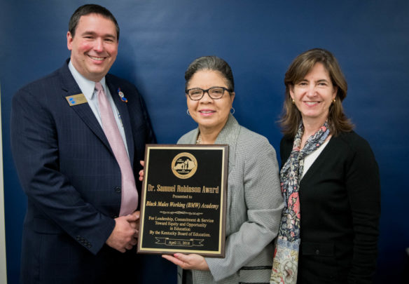 Roszalyn Akins, of the Black Males Working Academy, poses with Commissioner Stephen Pruitt and KBE Chair Mary Gwen Wheeler as she accepts the Dr. Samuel Robinson Award for the Black Males Working Academy. Photo by Bobby Ellis, April 11, 2018