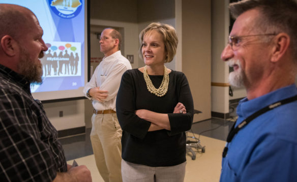Kentucky Department of Education Associate Commissioner Laura Arnold speaks with Sherman Cook, left, principal at Rockcastle County Area Technology Center, and Gerald Brinson, right, an automotive technology instructor at Pulaski County Area Technology Center. The three spoke following a town hall meeting on graduation requirements in London. Photo by Bobby Ellis, April 12, 2018