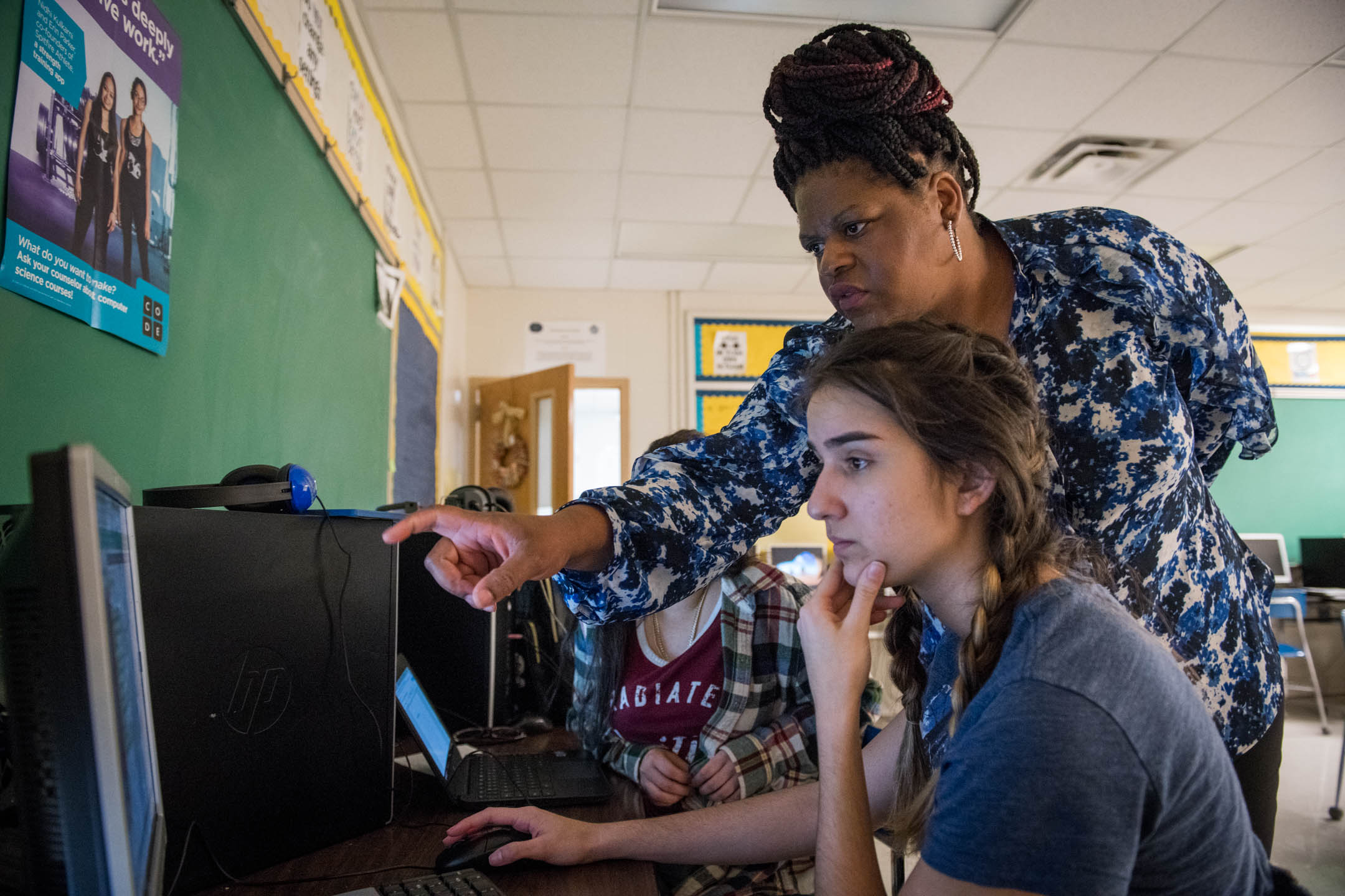 Teacher Aneesah Nu'Man, right, works with Yennifer Coca during her AP Computer Science Principles class at Iroquois High School (Jefferson County). Nu’Man is one of more than 100 teachers across the state now teaching computer science thanks to the computer science initiative, which includes a professional learning component aimed at training computer science teachers. Photo by Bobby Ellis, April 23, 2018