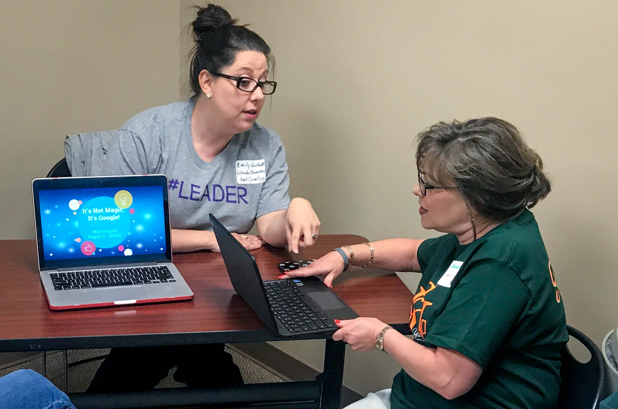 Emily Northcutt, left, a library media specialist at Hearn Elementary School (Franklin County), helps a colleague at a #KYGoDigital regional event last summer in Bowling Green, where she helped lead a track for library media specialists. Seven regional meetings will be held this summer, including an online event. Photo submitted, June 8, 2017
