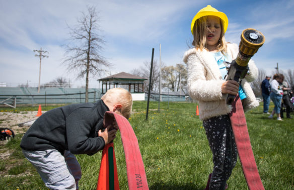 Cessy Winner, right, and her brother Charlie Winner play with a firehose during the Big Dig construction event at the Boone County Fair Grounds. The event was held as a way to introduce children to the construction and building industry. Photo by Bobby Ellis, April 21, 2018