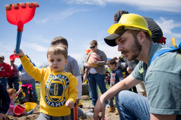 Stacey Price, right, helps his son, Jackson Price, look for buried candy in the sand pit section of the Big Dig. Photo by Bobby Ellis, April 21, 2018