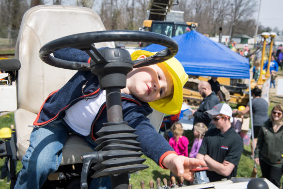 Andrew Burgas plays withe the controls of a machine used to asphalt roads. Photo by Bobby Ellis, April 21, 2018