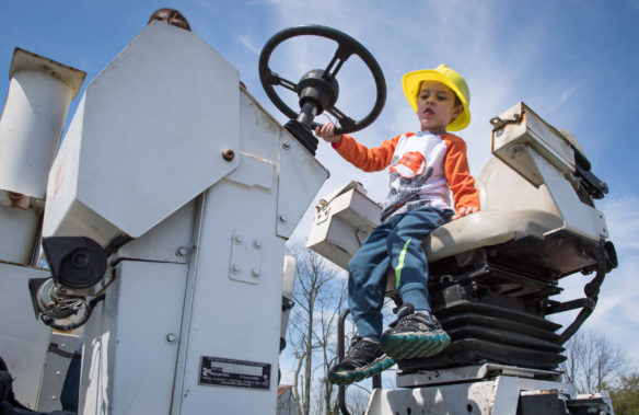 Christopher Furhman sits in the driver's seat of a machine used to blacktop roads at the Big Dig event at the Boone County Fair Grounds. The event, which was open to the public, allowed children a chance to sit on and operate different machines as a way to introduce them to the construction and building industry. Photo by Bobby Ellis, April 21, 2018