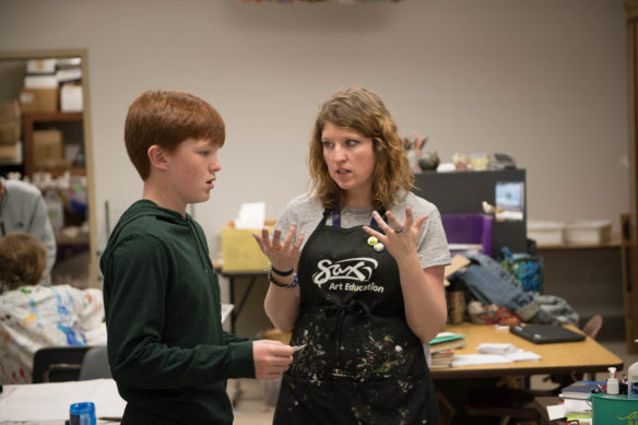 Kandice Kilcoyne, an art teacher at Drakes Creek Middle School (Warren County) and a mentor in the Academy at the Creek, talks with student Michael Lang. The Academy at the Creek is a daily period for the school's gifted and talented students in which they work on problems and explore projects that pique their interest. Photo by Bobby Ellis, April 25, 2018