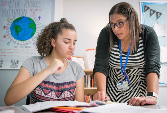 Jessica Dueñas helps Jadeynn White with a question during an English class at Oldham County Middle School. Dueñas, the 2019 Kentucky Teacher of the year, co-teaches as part of a two-person team that is a model for the district. Photo by Bobby Ellis, May 10, 2018