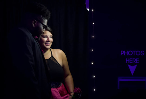 Tammra Means, right, and Jalin Benson print out photos from the photo booth at the Franklin County Senior Prom. Photo by Bobby Ellis, May 12, 2018