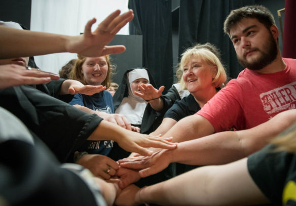 Frieda Gebert, the drama teacher at Boyle County High School, has the cast of "Sister Act" come together before the final performance at the Ragged Edge Theater in Harrodsburg. The school has to rent the theater because it does not have a performance space. Photo by Bobby Ellis, May 12, 2018