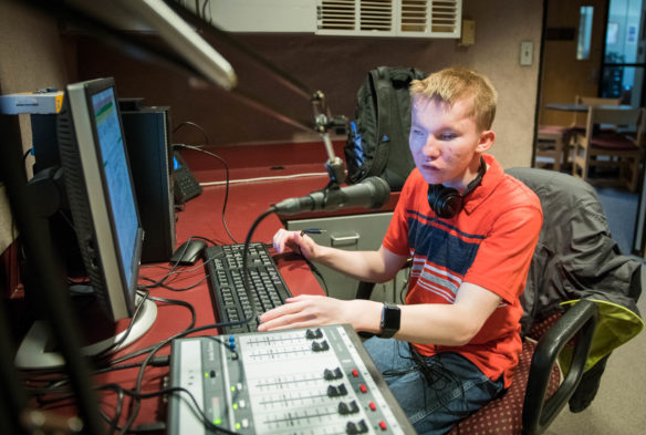 Alex Stine, a junior at the Kentucky School for the Blind, runs the control board of the school's new internet radio station. Stine, one of the station's engineers, helped get station up and running with the capability to play music and do live broadcasts from the studio and remote locations. Photo by Bobby Ellis, May 21, 2018
