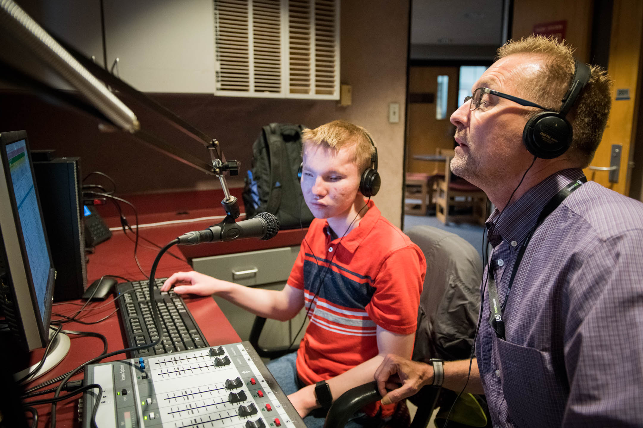 Alex Stine, left, a junior at Kentucky School for the Blind, and Dan Sharrard, the school's career and technical education teacher, man the controls at KSB's internet radio station, which began broadcasting earlier this spring. The station is an extension of the school's CTE program that allows students to develop skills they can use after they leave high school. Photo by Bobby Ellis, May 21, 2018