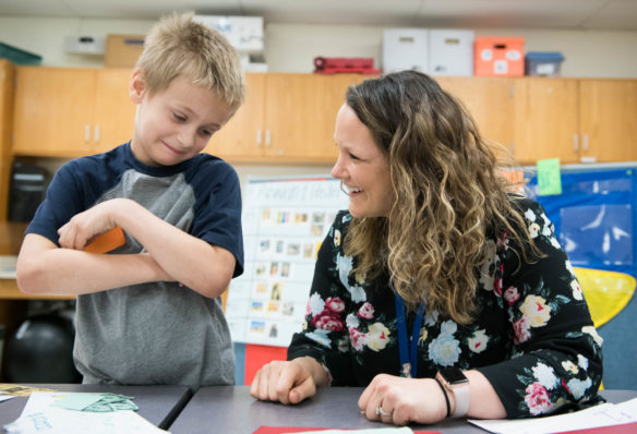 Carter Fretters, a 2nd-grader at Campbell Ridge Elementary School, left, spends "money" that he earned for good behavior. The rewards are part of a small-group focusing on behavior as part of Campbell County Schools' comprehensive counseling program. Photo by Bobby Ellis, May 23, 2018