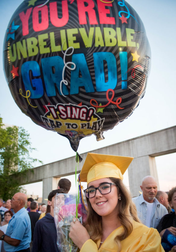 Amanda Holt holds a singing balloon, given to her by family members, after graduating from Campbell County High School Photo by Bobby Ellis, June 4, 2018