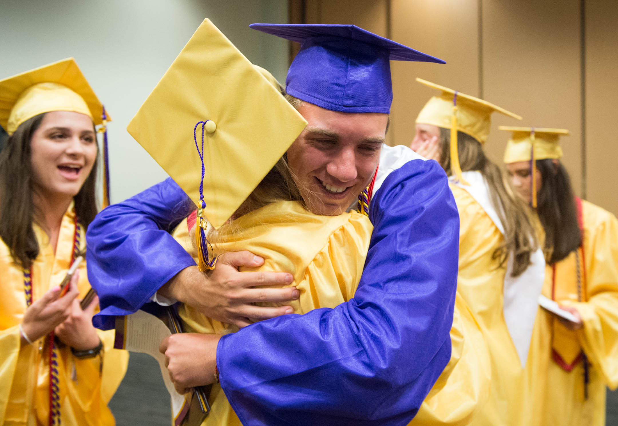 Mark Broering hugs Hope Schleper after the graduation ceremony. Photo by Bobby Ellis, June 4, 2018