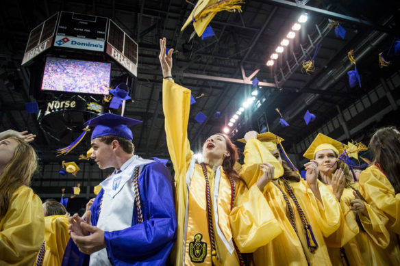 Jaclyn Fischesser, center, tosses her hat along with her classmates after graduation from Campbell County High School. Photo by Bobby Ellis, June 4, 2018