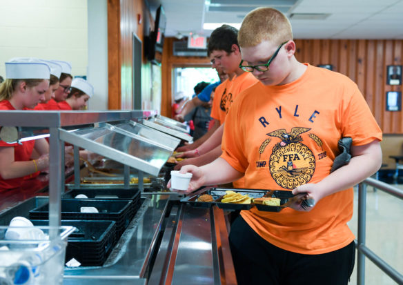 Wyatt Stubbeman, a student at Ryle High School (Boone County), goes through the lunch room at the FFA summer camp. Photo by Bobby Ellis, June 12, 2018