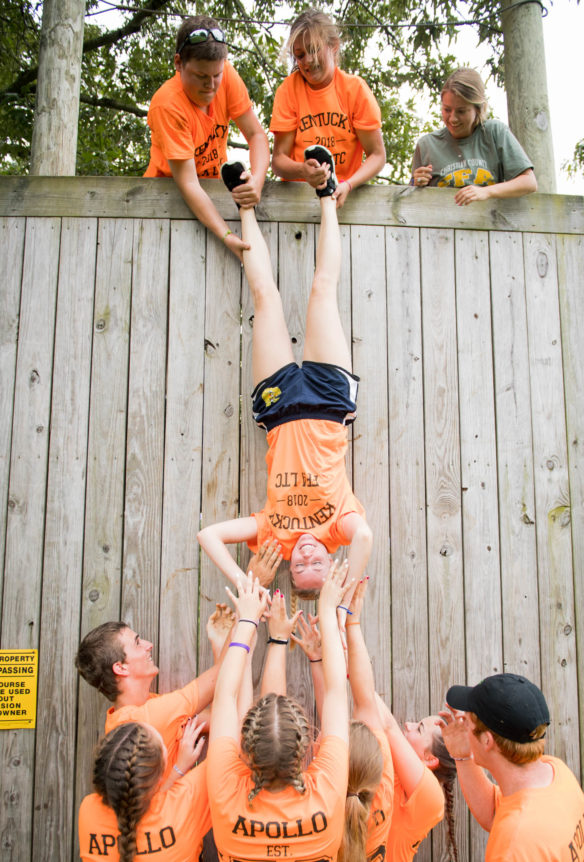 Faith Payne, of Apollo High School (Daviess County), is pulled up a wall by her ankles during a team building exercise at the FFA summer camp. Photo by Bobby Ellis, June 12, 2018