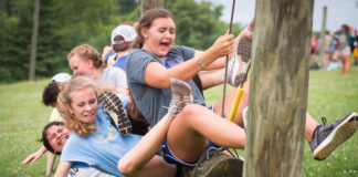 Abbi Jones and her teammates fall off of a suspended log during a team building exercise. Photo by Bobby Ellis, June 12, 2018