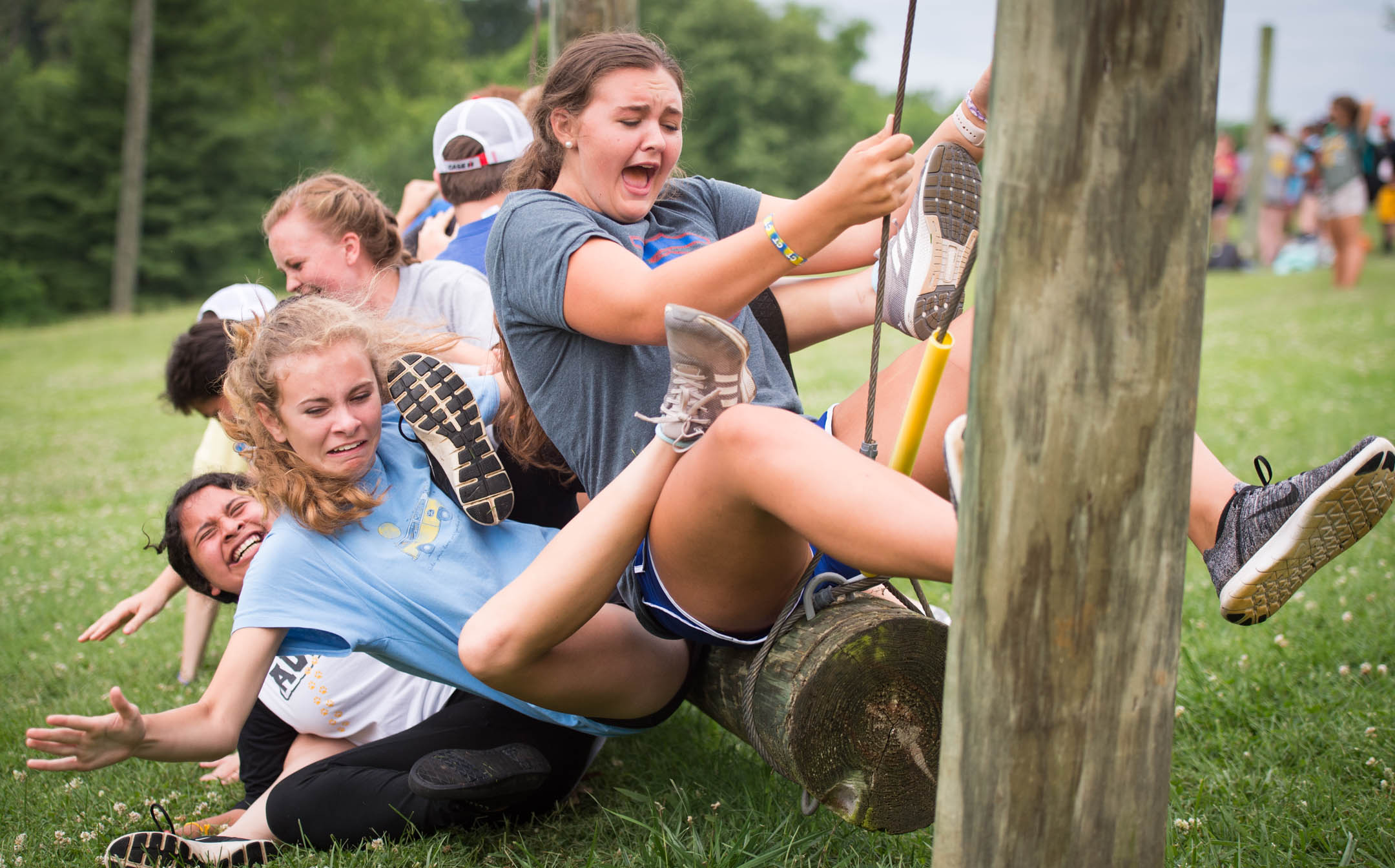 Abbi Jones and her teammates fall off of a suspended log during a team building exercise. Photo by Bobby Ellis, June 12, 2018
