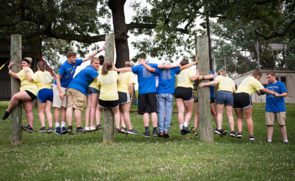FFA camp goers attempt to balance on a wire during team building exercises. Photo by Bobby Ellis, June 12, 2018