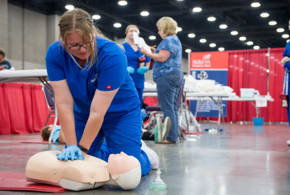 High school nursing students perform CPR on dummies as part of the SkillsUSA competition. Photo by Bobby Ellis, June 23, 2018