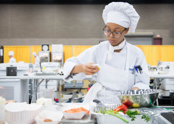Noni Anderson mixes ingredients as she competes in the high school culinary arts competition at SkillsUSA. Photo by Bobby Ellis, June 23, 2018