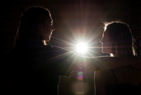 The Kentucky Department of Education is helping to raise awareness of human trafficking in schools through its participation in a statewide task force. Human trafficking can take the form of either sex trafficking or labor trafficking. The image shows a woman with her hand on the shoulder of a girl, leading her toward a light. Photo illustration by Bobby Ellis