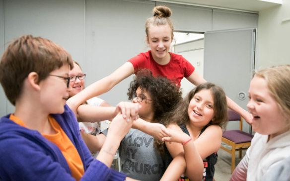 Elizabeth Gallagher, a student at duPont Manuel (Jefferson County), leads her group in the Group Knot game at the STEM You Can! camp at the Bon Air Free Public Library in Louisville. Photo by Bobby Ellis, June 13, 2018