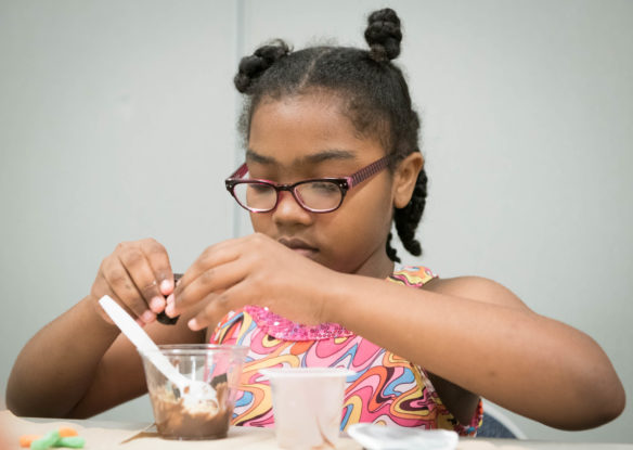 Yasmine Legendre makes dirt pudding, used to simulate food chains and environmental ecosystems. Photo by Bobby Ellis, June 13, 2018