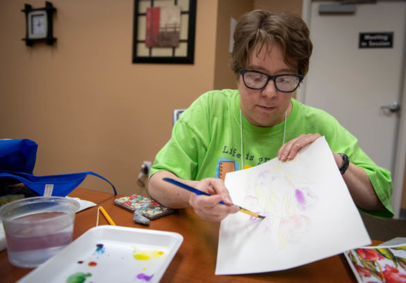 Sandy Phelps, an art teacher at Oak Hill Elementary (Pulaski County) paints flowers during a watercolor painting class at the Festival of Learnshops at Berea. During the workshops, teachers can take classes to count towards professional development. Photo by Bobby Ellis, July 19, 2018