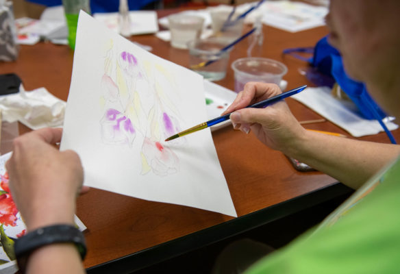 Sandy Phelps, an art teacher at Oak Hill Elementary (Pulaski County) paints flowers during a watercolor painting class at the Festival of Learnshops at Berea. During the workshops, teachers can take classes to count towards professional development. Photo by Bobby Ellis, July 19, 2018