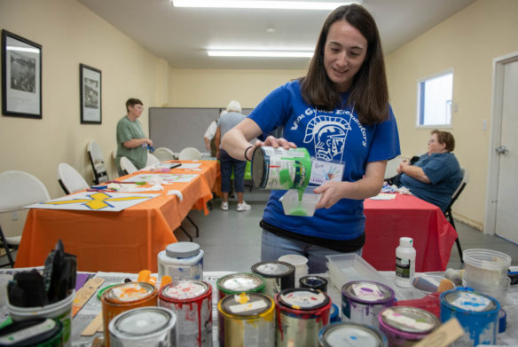 Erin Hubbard, an art teacher at Vine Grove Elementary (Hardin County), pours paints during a quilt block painting class. Photo by Bobby Ellis, July 19, 2018