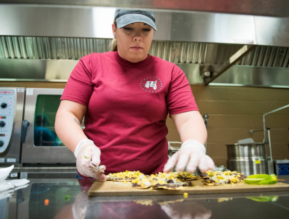 Kelsy Harmon, a chef at New Castle Elementary (Henry County), makes Eagle Pizza as part of the nutrition training lab at Henry County Middle School. Photo by Bobby Ellis, Aug. 1, 2018