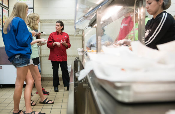 Kristin Watkins, a professional chef from Memphis, Tennessee, tells Henry County High School students different food options to try as part of a taste testing portion of a nutritional workshop lab. Photo by Bobby Ellis, Aug. 1, 2018