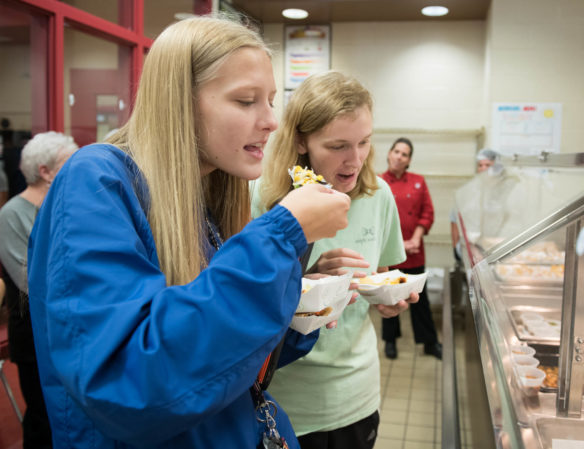 Victoria Williams, left, and Kierstin Prentice try food made the cooks and chefs at the nutritional training lab at Henry County High School. Photo by Bobby Ellis, Aug. 1, 2018