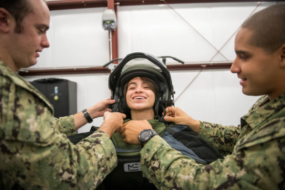 Gueneverie Diffenbacher, an 11th-grader at the Academy at Shawnee (Jefferson County), is helped into a bomb suit by EOD2 David Eninger, left, and EOD2 Abraham Ruic. Photo by Bobby Ellis, Aug. 23, 2018