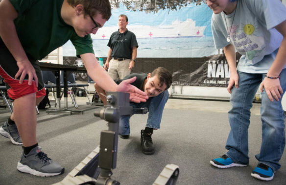 Students in the NJROTC program play with a bomb disposal robot brought by members of the U.S. Navy during a visit to the class. Photo by Bobby Ellis, Aug. 23, 2018