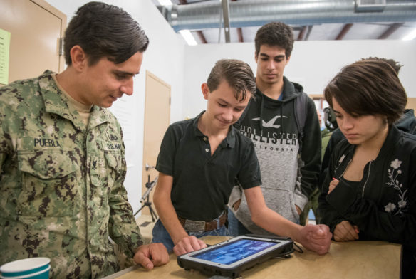 Avery Cox, a 9th-grader at the Academy at Shawnee (Jefferson County) drives an EOD robot with the help of EOD3 Jonathan Puebla. Photo by Bobby Ellis, Aug. 23, 2018