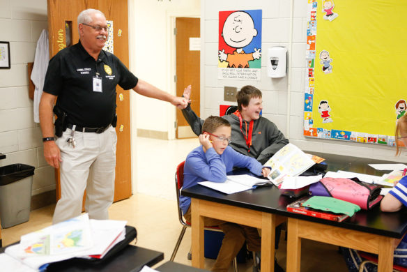 Charles Parker, a member of a member of the Laurel County schools’ Security Response Team, high-fives a student as he drops into a class at South Laurel Middle School. Team members have quickly become accepted by the students and staff at the schools where they are assigned. Photo by Mike Marsee, Sept. 27, 2018