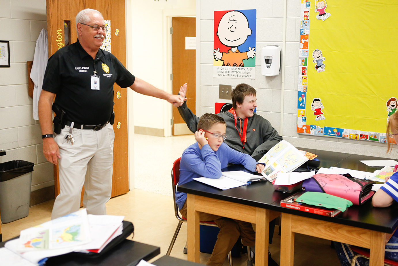 Charles Parker, a member of the Laurel County schools’ Security Response Team, high-fives a student as he drops into a class at South Laurel Middle School. Team members have quickly become accepted by the students and staff at the schools where they are assigned. Photo by Mike Marsee, Sept. 27, 2018