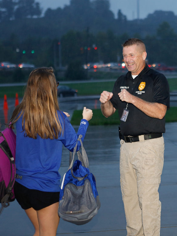Bobby Day, a member of the Laurel County schools’ Security Response Team, greets a student with a smile and a double fist-bump as she arrives at North Laurel Middle School for the start of the school day. The team, which consists primarily of retired law enforcement officers, was formed as a way to improve security at the district’s schools, and its members receive specialized training. Photo by Mike Marsee, Sept. 27, 2018
