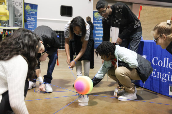 A group of students from Frederick Douglass High School got an unusual lesson about working together. The students, who each were holding a piece of rope that held up a ball, had to figure out how to move together to lower the ball onto a pipe. It only took a couple of tries. That takes teamwork! Photo by Megan Gross, Nov. 5, 2018