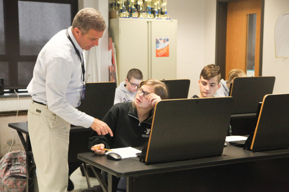 David Sandlin makes a point to student Cameryn McPherson during Sandlin’s financial literacy class at Walton-Verona High School (Walton-Verona Independent). Sandlin, who worked as an investment consultant prior to becoming a teacher, will serve on both a business and education advisory panel and a standards revision and writing committee during the process of developing financial literacy standards. Photo by Megan Gross, Nov. 19, 2018