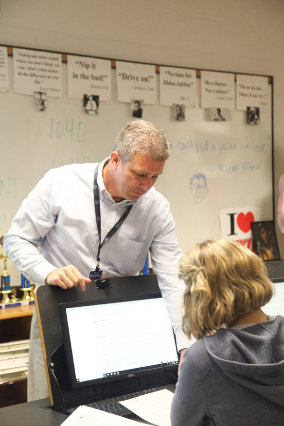 David Sandlin, a business teacher at Walton-Verona High School (Walton-Verona Independent), talks with student Anna Myers during his financial literacy class. Sandlin said a law passed earlier this year that establishes financial literacy as a requirement for graduation should help put students on the path to financial independence and success. Photo by Megan Gross, Nov. 19, 2018