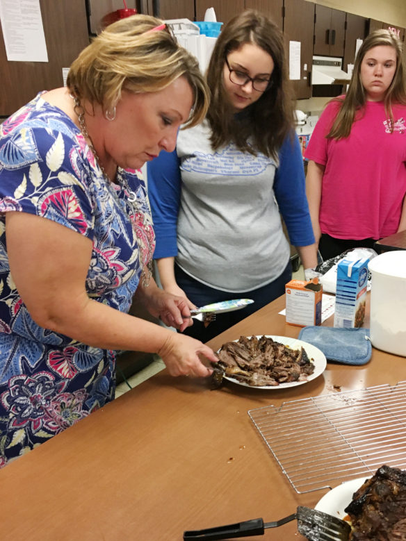 Rosemary Jones, left, a former family and consumer sciences teacher at Bell County High School, works with students on a demonstration during a culinary class. Jones, who recently retired after 26 years in teaching, received the Association for Career and Technical Education Region II Carl Perkins Community Service Award, which recognizes people who have used CTE to make a significant impact on their community and demonstrated leadership in programs and activities that promote student involvement in community service. Photo submitted
